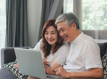 Asian senior couple using laptop at home. Asian Senior Chinese g